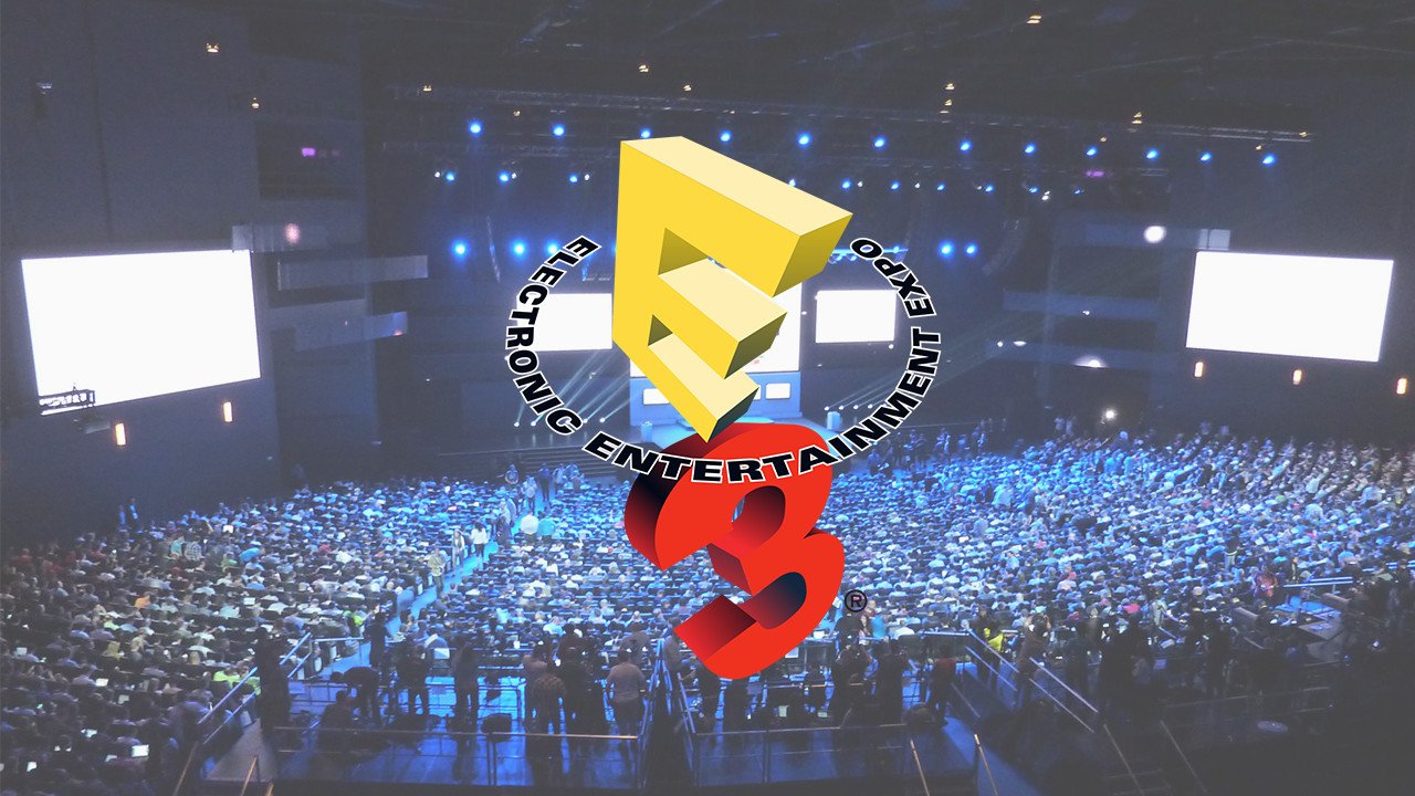 One of the older logos for E3 over a crowd of people at the event.